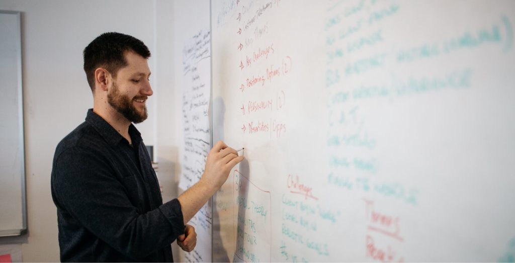 Daylight team member working at a whiteboard